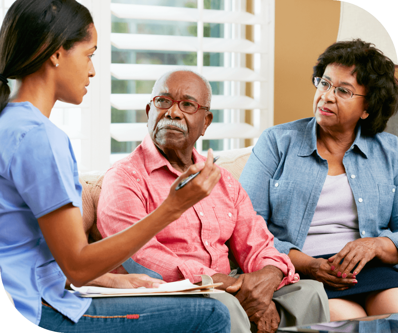 Caregiver consults with senior couple.